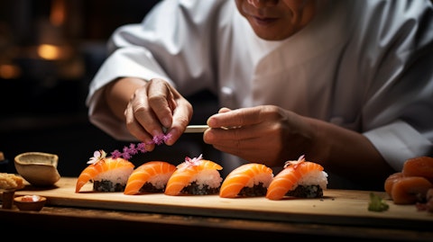 A close-up of a sushi chef, displaying his care and attention to detail in making a dish.