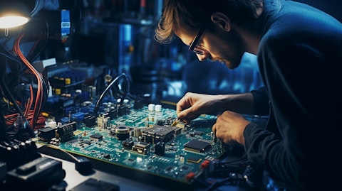 A technician working diligently with a soldering iron, assembling a circuit board.