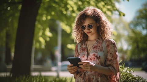 A woman using her mobile device to access her online banking account on a sunny day.