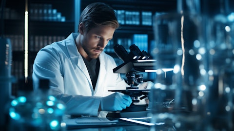 A scientist studying a DNA sample under a microscope in a laboratory.