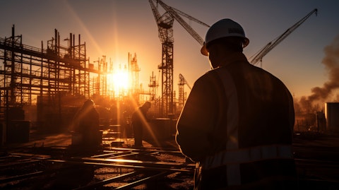 A construction site at dawn, a workers silhouetted in the morning sun, working on a utility plant.