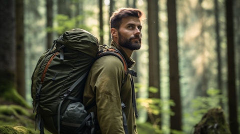 A hiker in a forest with a backpack of outdoor equipment highlighting the company's lifestyle products.