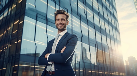 A smiling employee in front of a modern building surrounded by a vibrant cityscape.