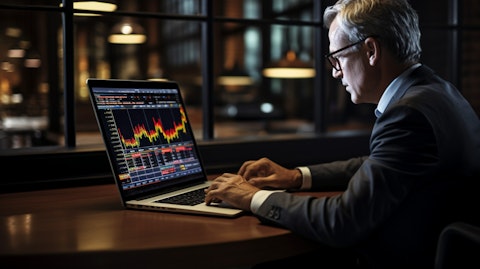 A portfolio manager typing away on a laptop, analyzing debt securities for private middle market U.S. companies.