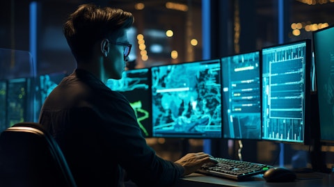 A software engineer in front of a monitor making coding changes for cloud-native solutions.