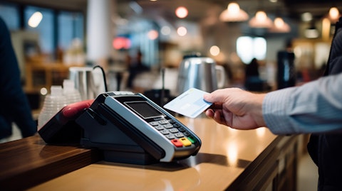 A customer making a purchase at a modern retail store terminal, showing the ubiquity of the company’s payment solutions.