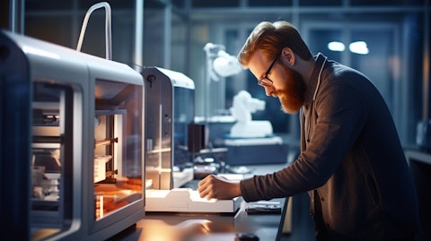A technician inspecting a 3D printer producing a component with pinpoint accuracy.
