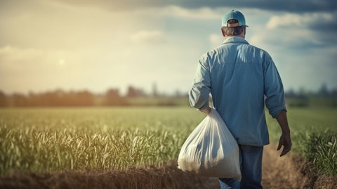 A farmer carrying a bag of fertilized over his shoulder signifying the fertilizers the company produces.