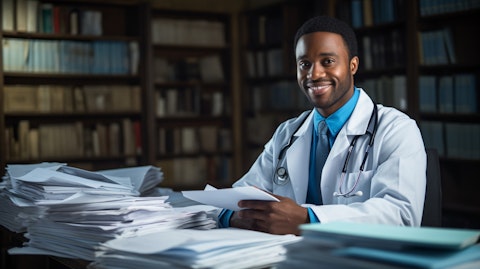A smiling health worker surrounded by medical papers.