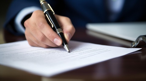 A closeup of an insurance document with a pen signing its content.