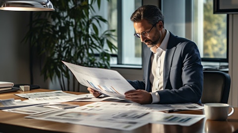 A businessperson examining financial graphs and charts of the company's portfolio, while surrounded by residential mortgage loan documents.