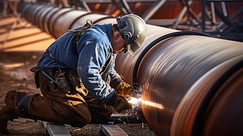 A construction worker welding a gas pipeline on a gas storage facility.