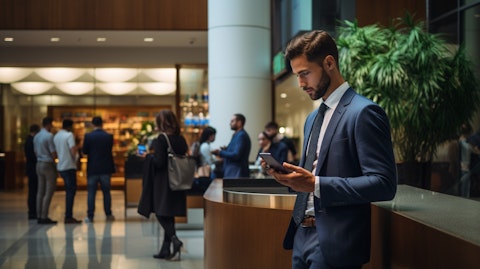 A customer on the phone in a busy bank lobby, discussing their financial portfolio.