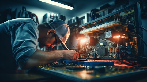 A technician in a laboratory adjusting the components of a gaming power supply unit.