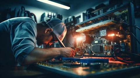A technician in a laboratory adjusting the components of a gaming power supply unit.