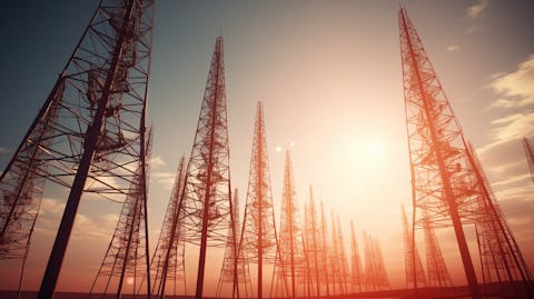 A row of powerful broadcast antennae towers standing tall.