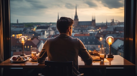A traveler having a delicious meal at a local restaurant with a view of the city.