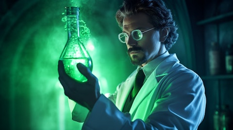 A scientist in a lab coat holding a flask with a green, glowing liquid.