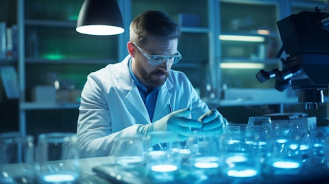 A scientist in a lab coat studying a petri dish in a sterile laboratory environment.