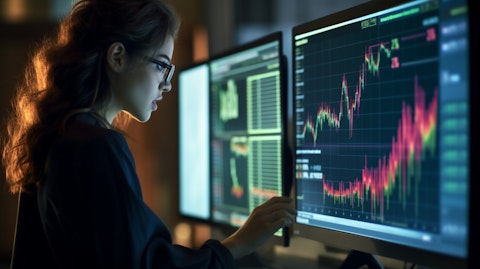 A woman analyzing a large dataset on a computer screen, emphasizing the importance of analytics in the technology sector.