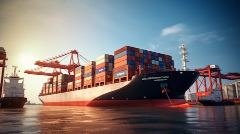 A large cargo ship in a harbor port, teeming with Twenty-Foot Equivalent Units (TEUs).