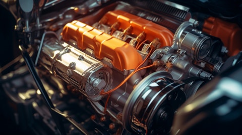 A close-up of a car engine, its components illuminated in the light.