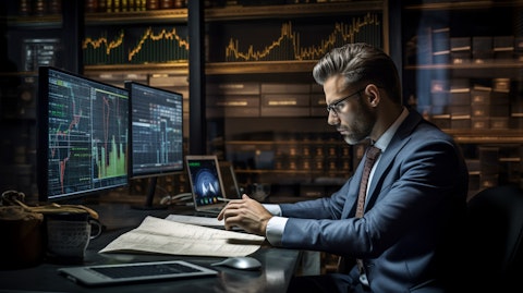 A professional broker in a suit and tie working behind a trading desk.
