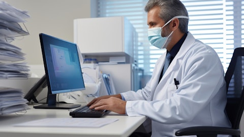 A doctor wearing a face mask utilizing modern telemedicine equipment as part of a telehealth software.