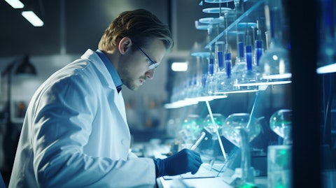 A researcher in a lab coat monitoring a biotechnological experiment.