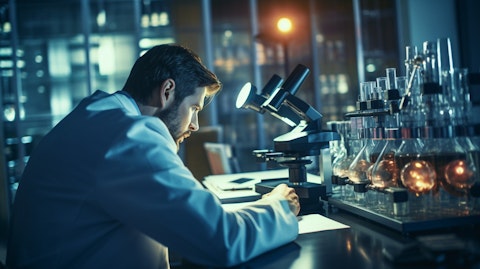 A researcher in a lab coat observing a microscope, studying molecules in the companys antibody therapeutics.