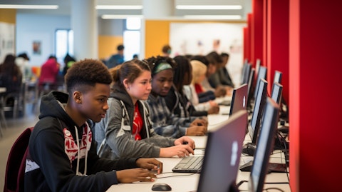 A line of students working on their computers in an after-school tutoring center.
