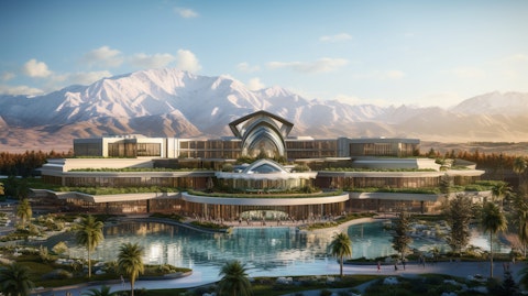 An exterior shot of a bustling resort and casino, framed by the stability of a nearby mountain range.