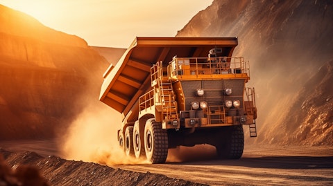 A modern mining truck, winding its way through a large open pit mining operation.