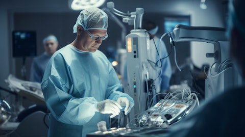 A surgeon demonstrating single-incision surgery on a robot in the operating theatre.