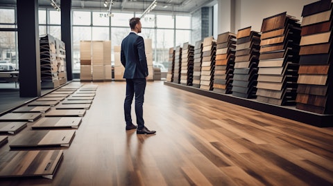 A person standing in a showroom admiring the range of laminate flooring.