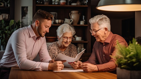 A financial advisor discussing retirement plans with an elderly couple in their home.
