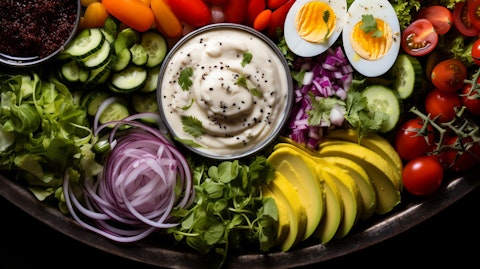 A close-up image of a colorful salad platter with toppings and dressings.