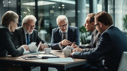 A brokerage employee huddled with a group of retirees discussing retirement portfolios.
