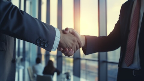A successful businessman shaking hands with a client in a modern office building, celebrating a successful financial transaction.
