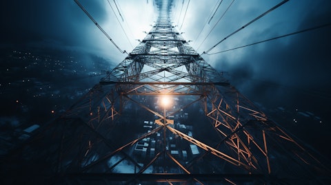 An overhead view of a powerful electricity transmission tower with in motion cables.