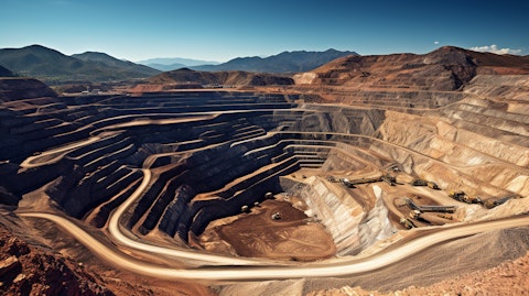 An open-pit mine framed by a mountain range, highlighting the company's vast mining concessions.