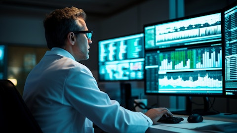 A research scientist in a lab coat examining data on a computer screen demonstrating the trials and development of new drugs for CNS diseases.