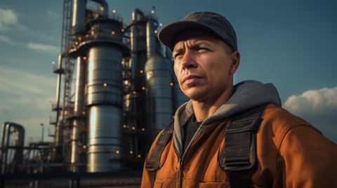 A farmer in overalls standing outside a methane conversion facility.