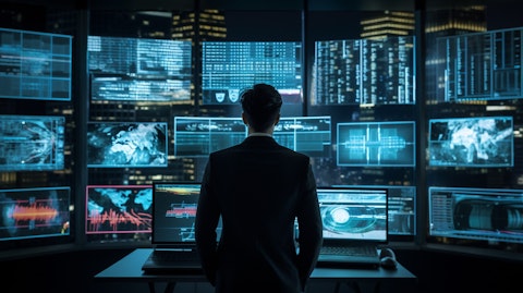 A network analyst in front of a wall of screens analyzing financial data.