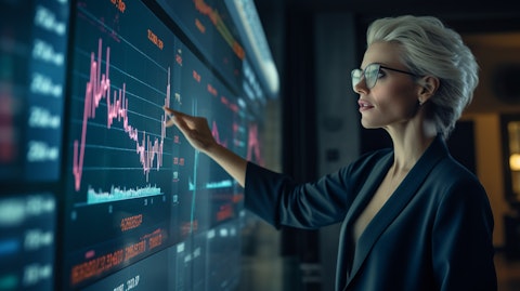 A businesswoman pointing to a chart on a glass board, highlighting recent successful investment trends.