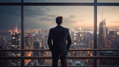 An executive standing in front of a modern high-rise overlooking a bustling city.