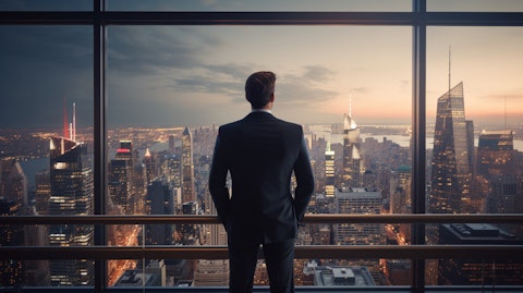 An executive standing in front of a modern high-rise overlooking a bustling city.