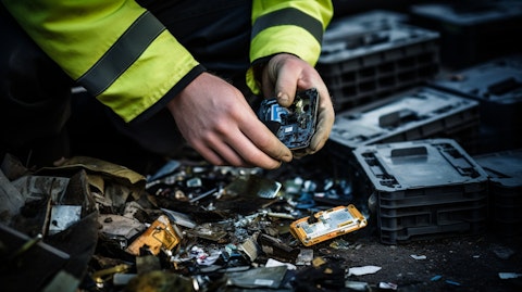 A person inspecting a lithium-ion battery that is being recycled.