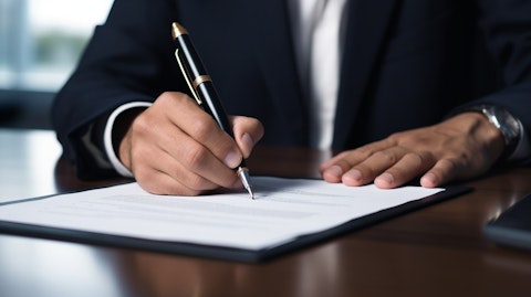 A close-up of a hand signing a contract, representing the employment solutions of the company.