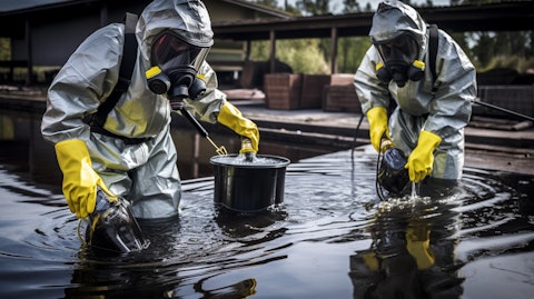 A biohazard waste disposal team safely transferring contaminated water for treatment.